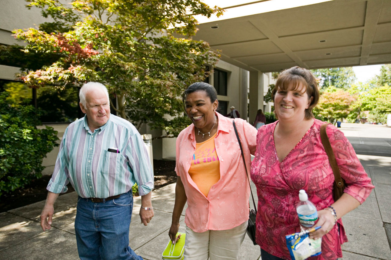 Three friendly patients leaving a clinic.