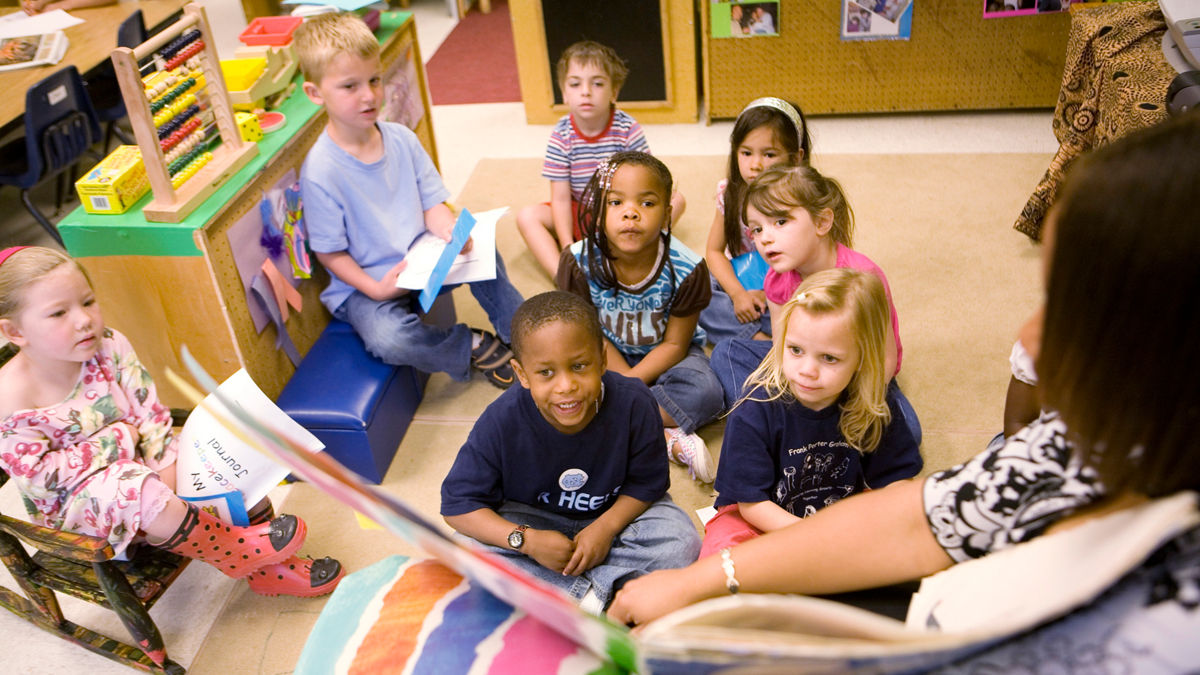 Josh Singleton and other preschool students listen as their teacher Erin Webb, reads them a book. Frank Porter Graham Child Development Center. Chapel Hill, North Carolina.