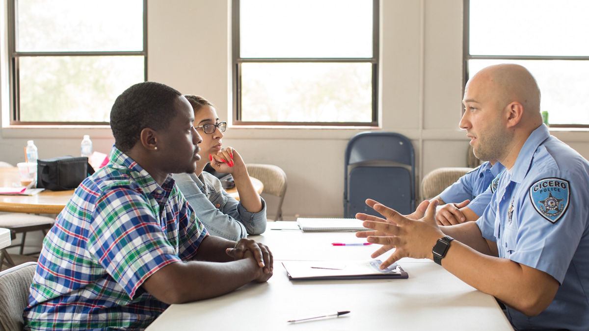 A policeman talking with students.