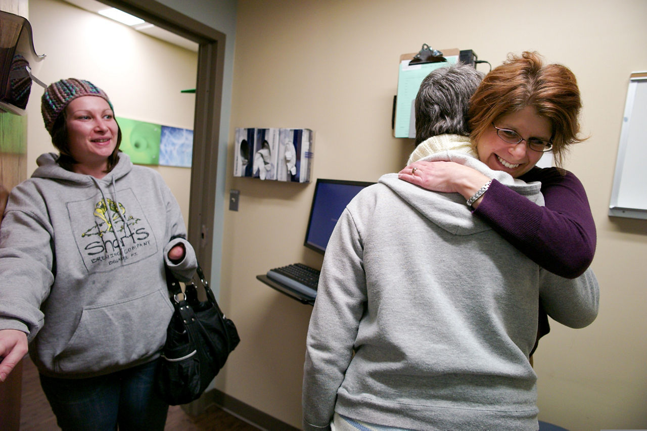 Anna Piscopo (slender, glasses, white knit scarf) visits with both Scott Haga, the PA and Shelly Virva, the social worker. Anna is accompanied by her daughter, Roberta Earl. This is an emotional day for Anna as she is preparing to begin chemo next week and evidently this is just one of her many battles. She has been alcohol free for 17 years, she said proudly.