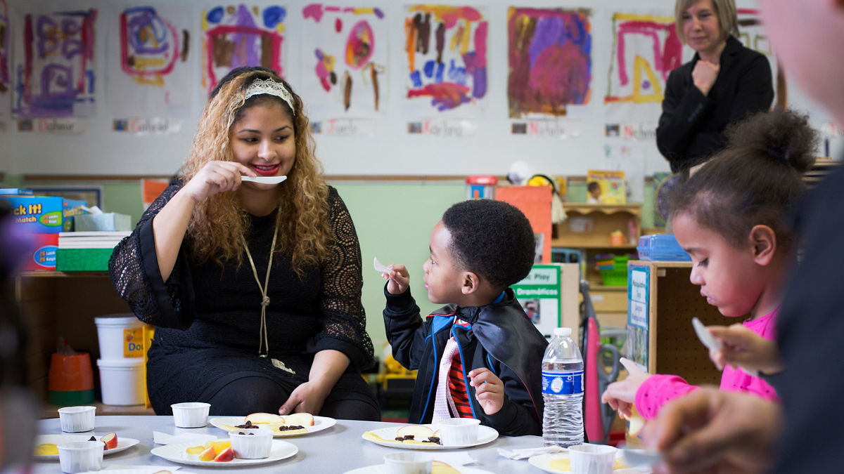 Children and their parents participate in an activity with representatives of the Food Trust at the Center for Family Services Pine Street School in Camden, NJ. Kim Fortunado of Campbell's also participated. Cameden, NJ, (Photo by Samantha Appleton)