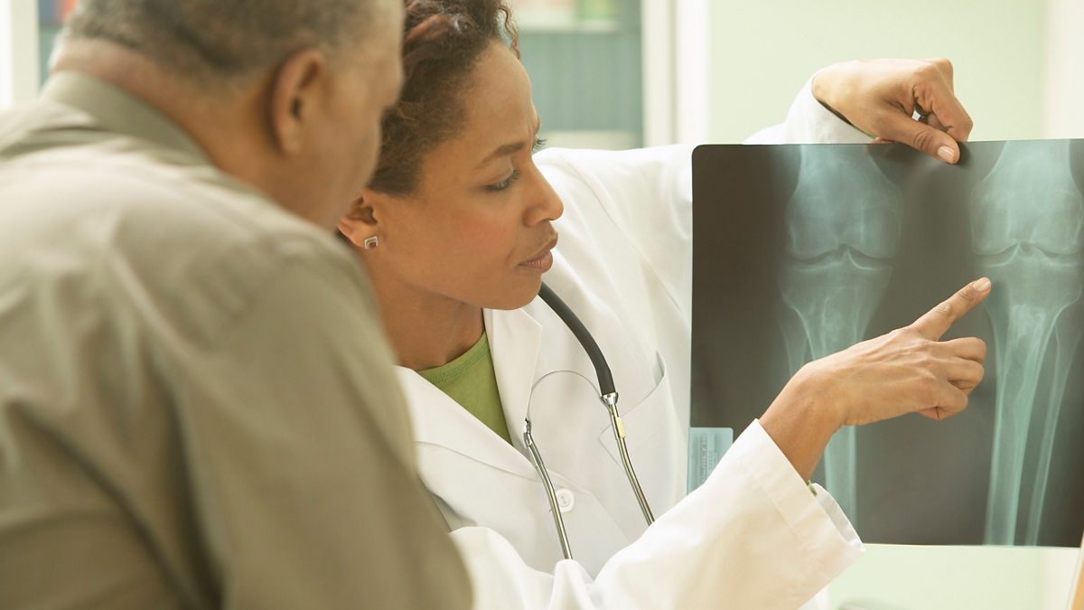Doctor and patient examining X-rays.  Aligning Forces