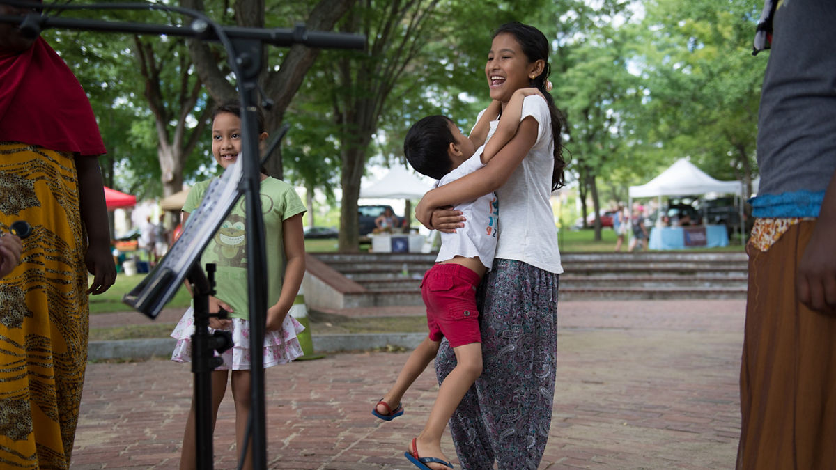 Children listen to free music in Victory Park in Manchester, N.H. on Thursday, Aug. 18, 2016.