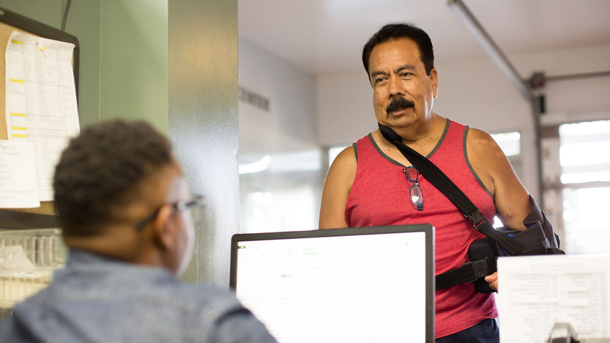 A man receives assistance at a homeless intake facility.