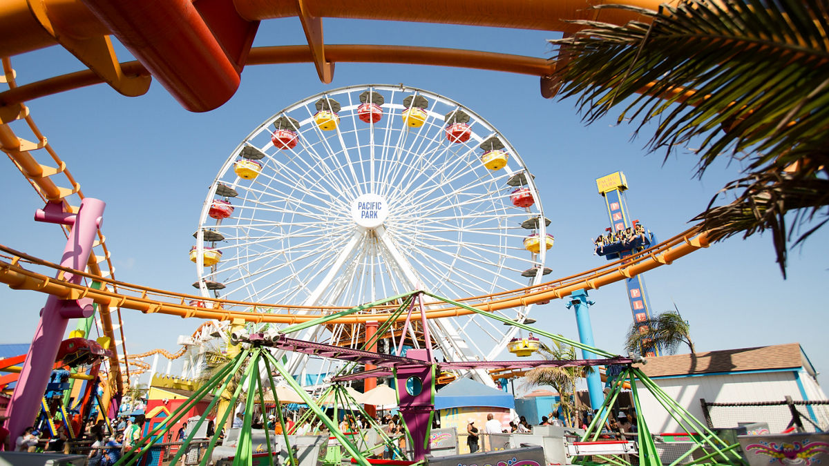 A colorful Ferris wheel on a pier.