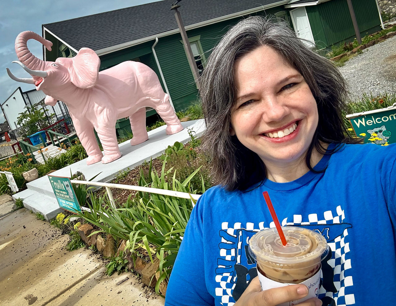 Britt in front of a pink elephant statue. 