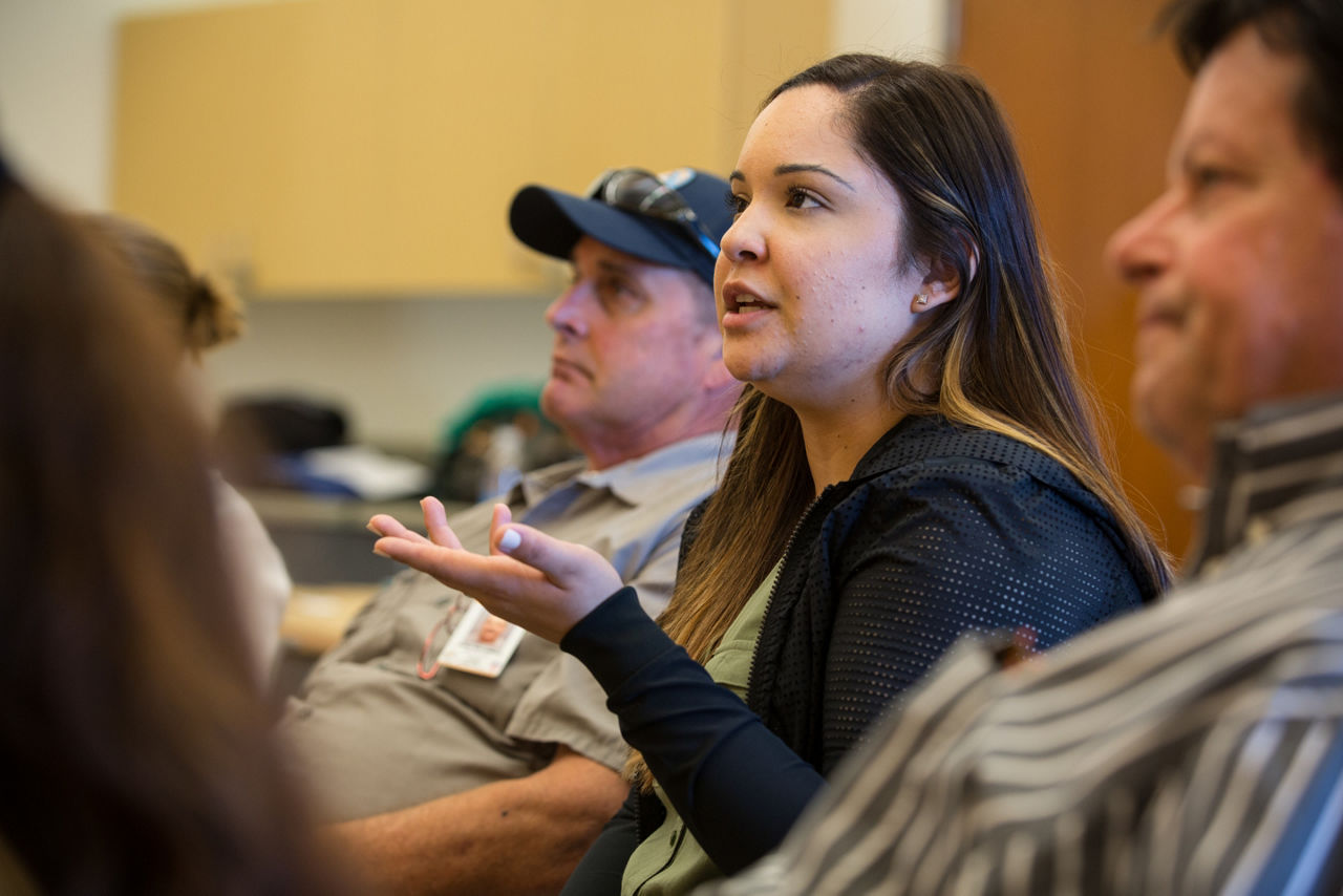 Woman speaking at community meeting.