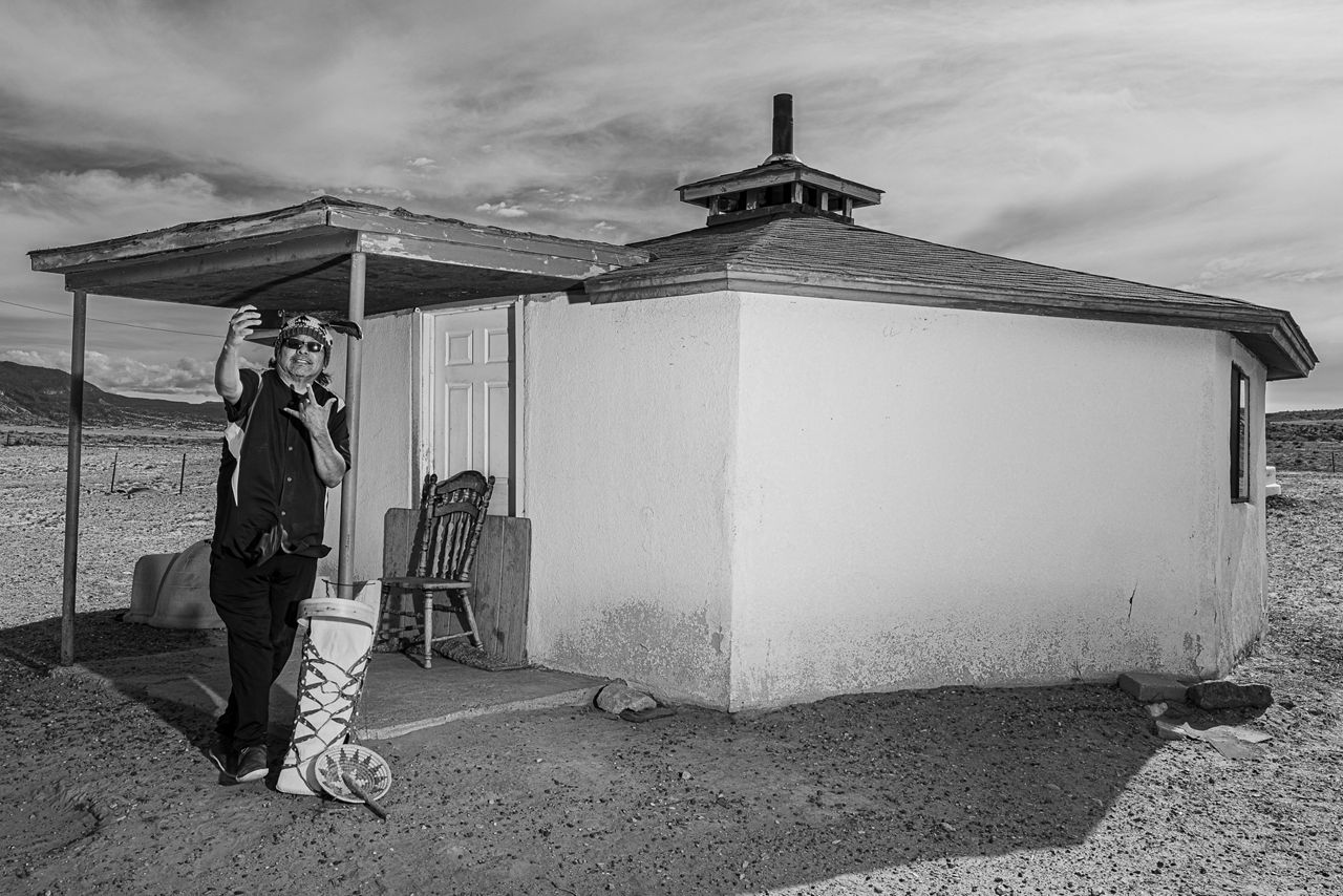 Curtis Ray standing in front of the hogan where he was born.
