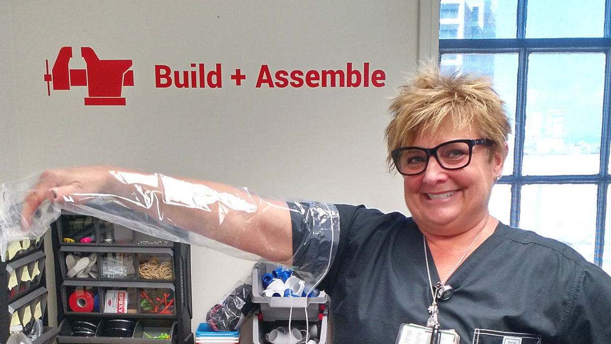 A nurse presents a prototype of the shower sleeve she designed.