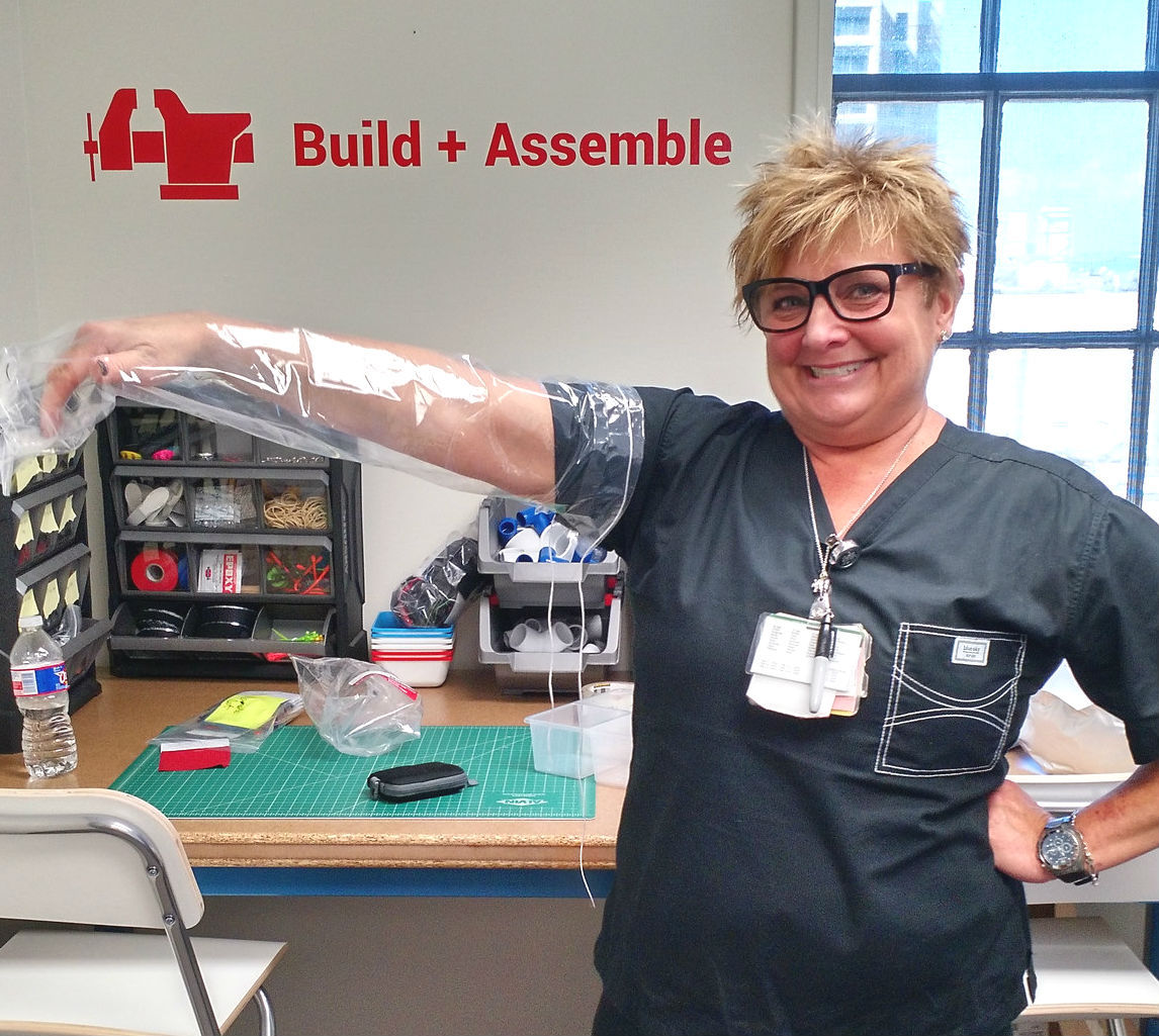 A nurse presents a prototype of the shower sleeve she designed.