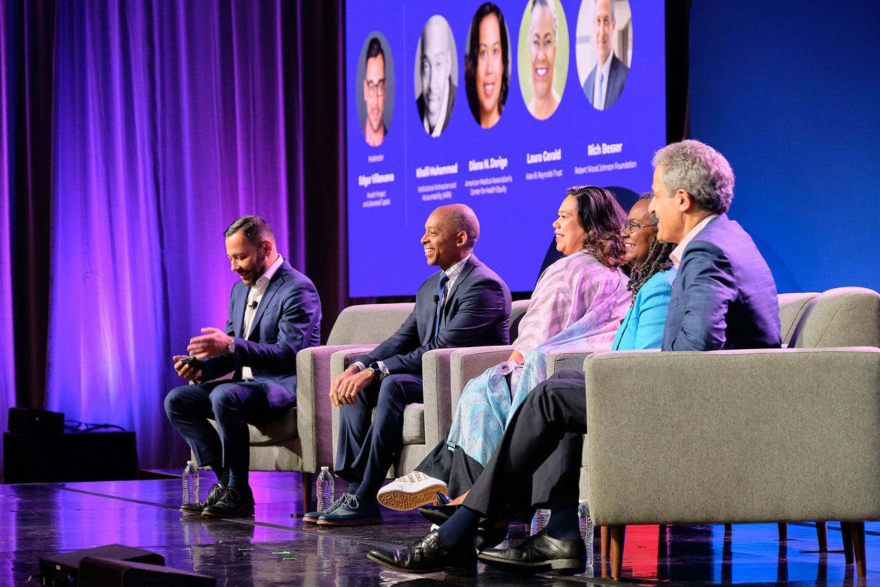 Rich Besser speaks with a panel at a health equity summit