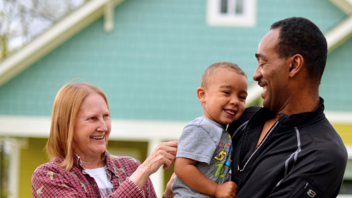 A family standing in front of their home.