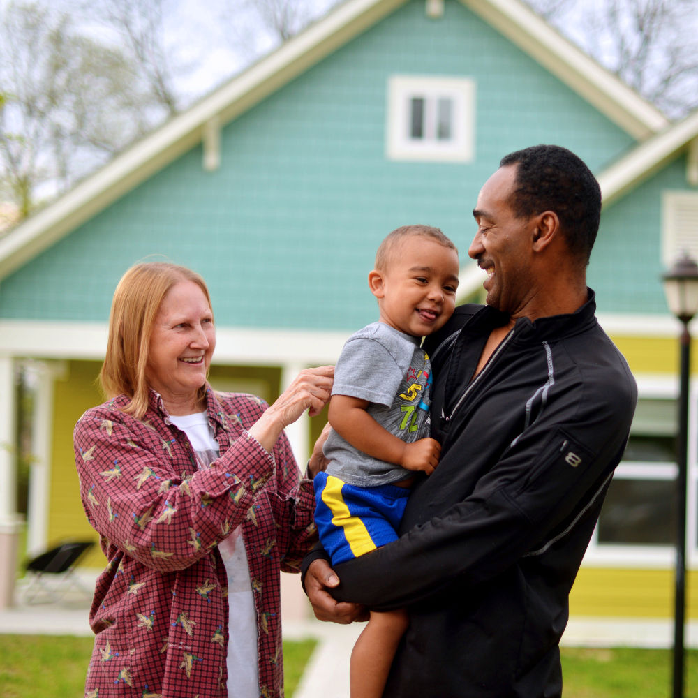 A family standing in front of their home.
