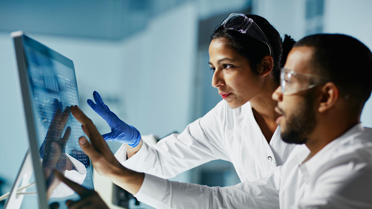 Scientists working on computer in a laboratory.