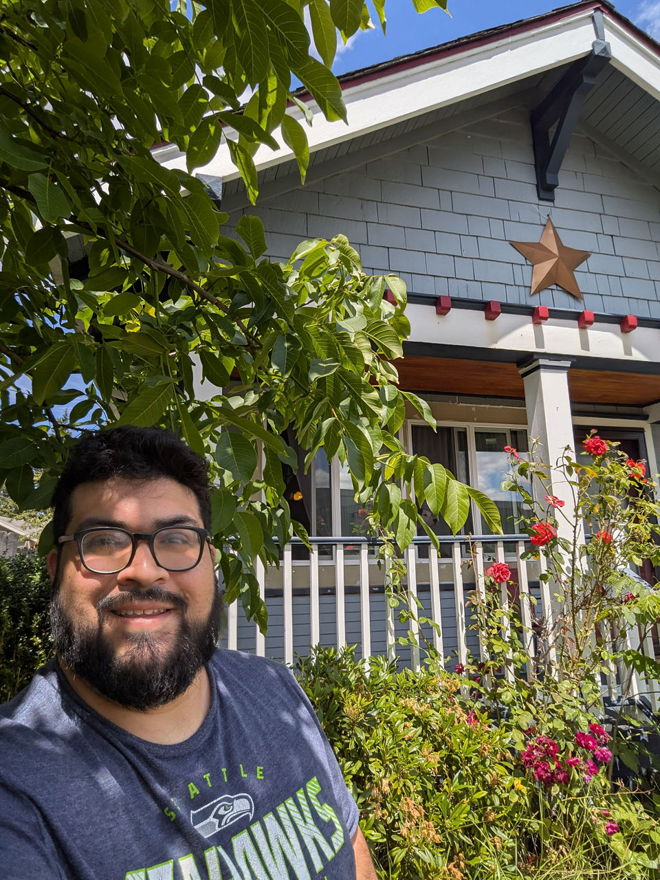 Guillermo standing in front of his parents' house.