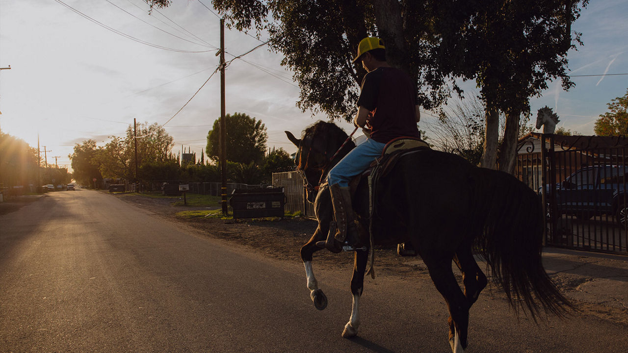 Riding a horse through a community