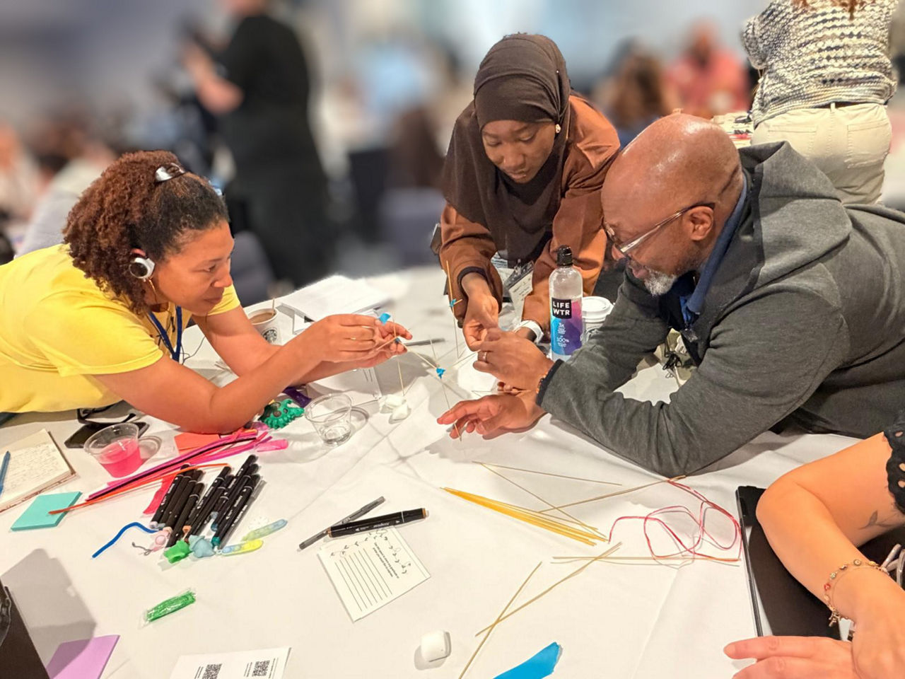 Members of the JUSTICE SQUARED team collaborate during a hands on activity at a Justice Equity Leadership Academy session.