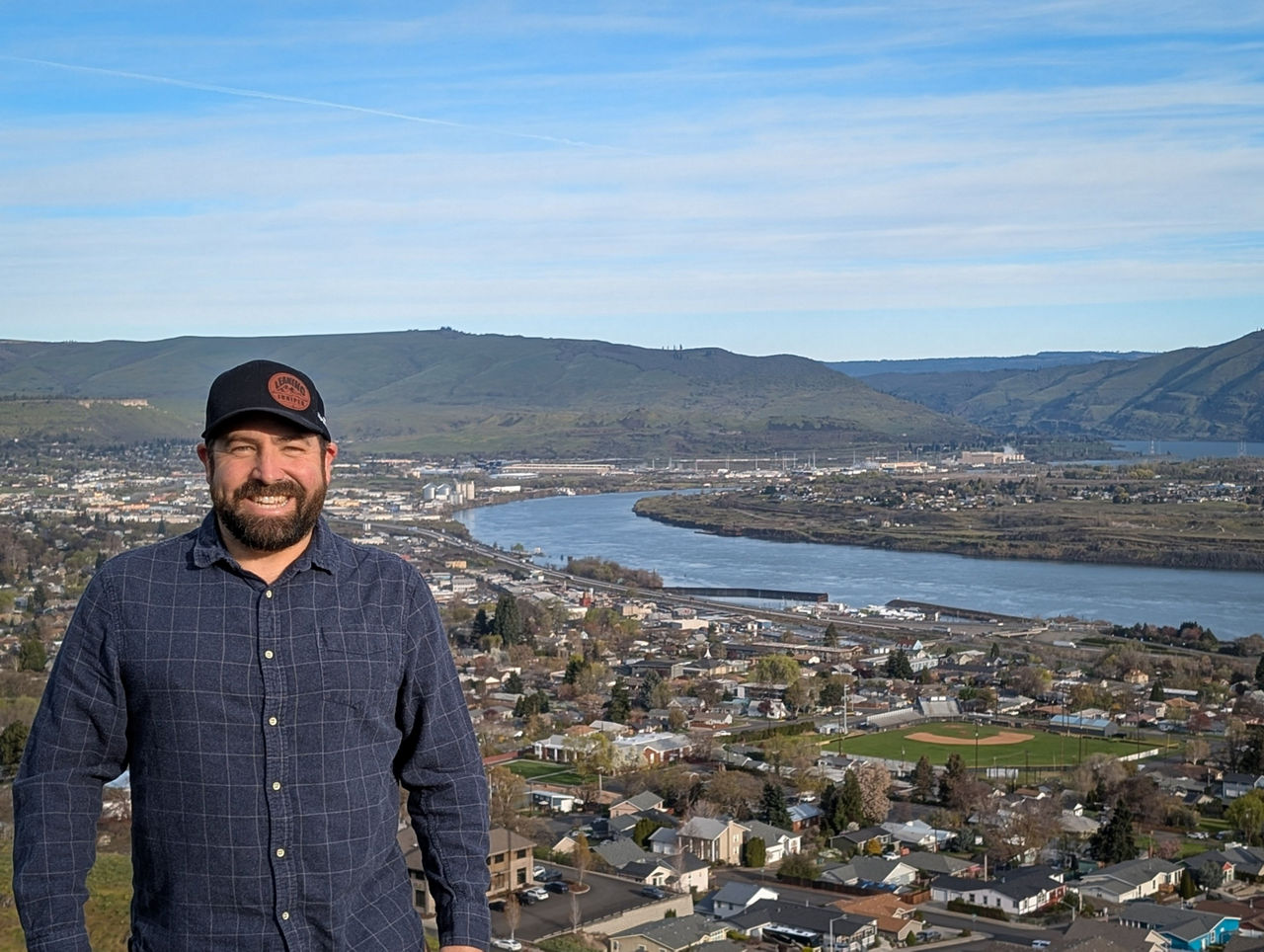 Jay pictured with the hillside of The Dalles, Oregon in the background.