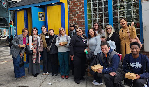 A group photo of Jegna Council members in front of a brick building.