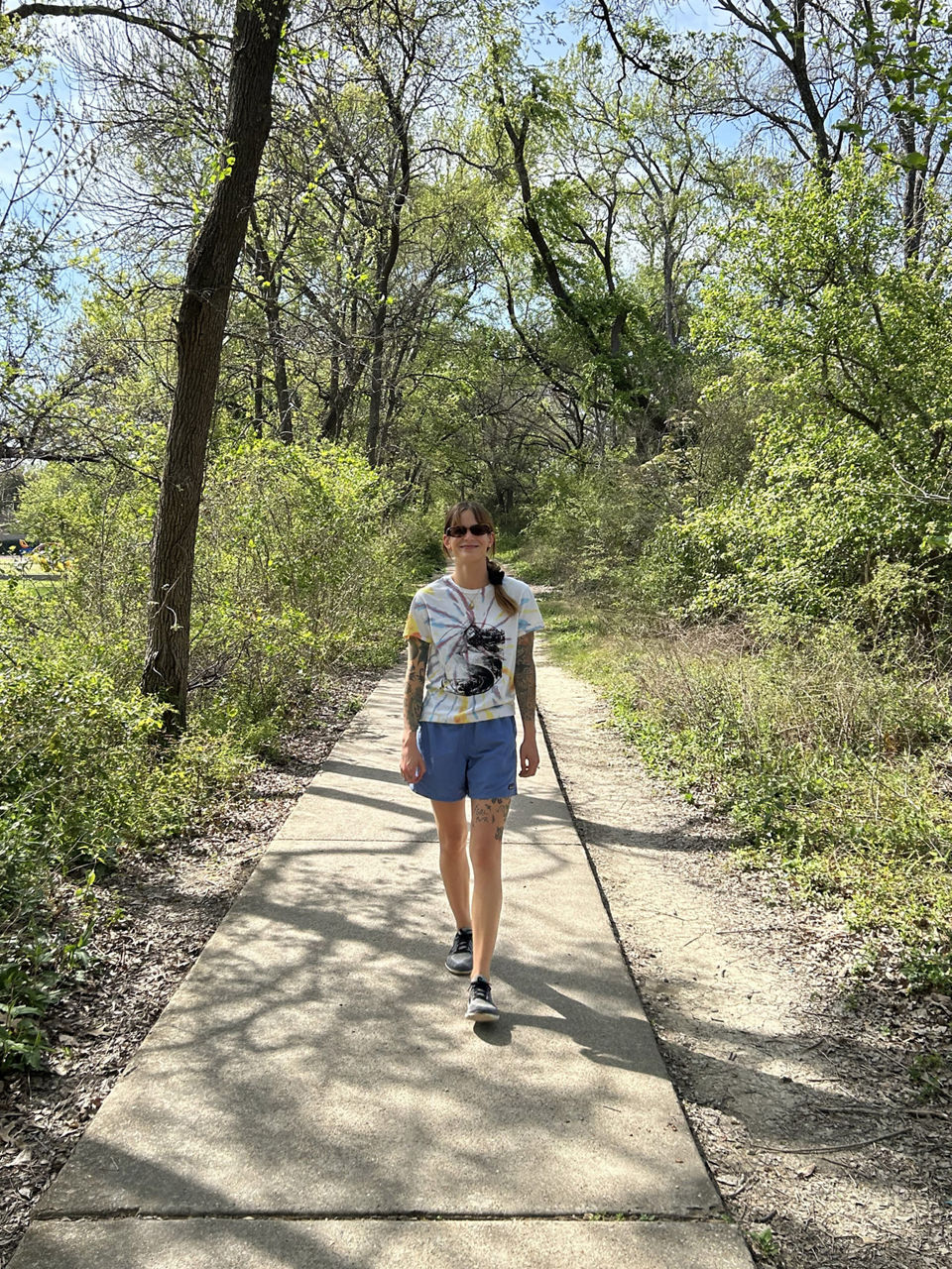 Melanie walking on a wooded path in Dallas, Texas.