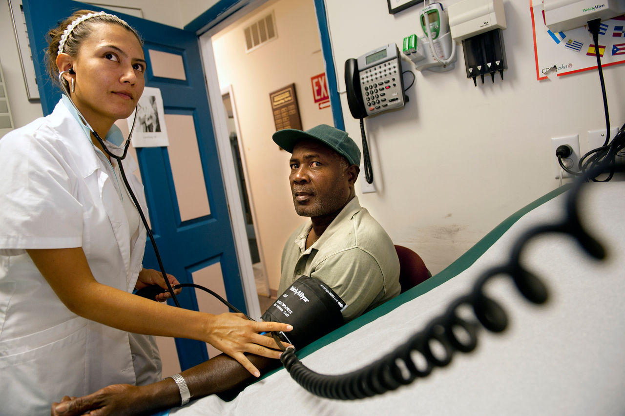 A nurse takes a patient's blood pressure.