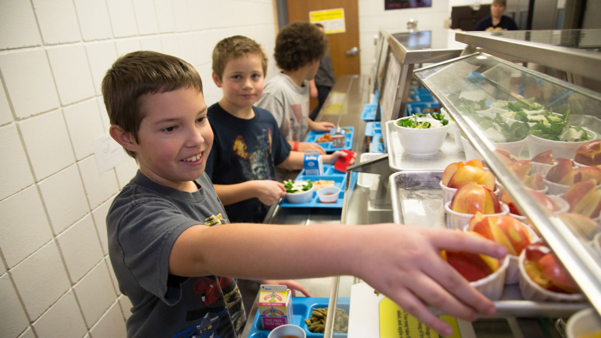 Signs of Progress: Nebraska. Children exercise during PE class and eat a healthy snacks at Fredstrom Elementary in Lincoln, NE. Children can also be seen touring the schools kitchen.