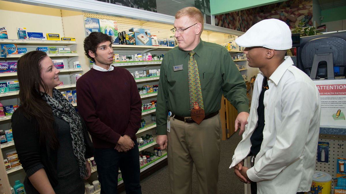 A group of adults talking in a pharmacy.