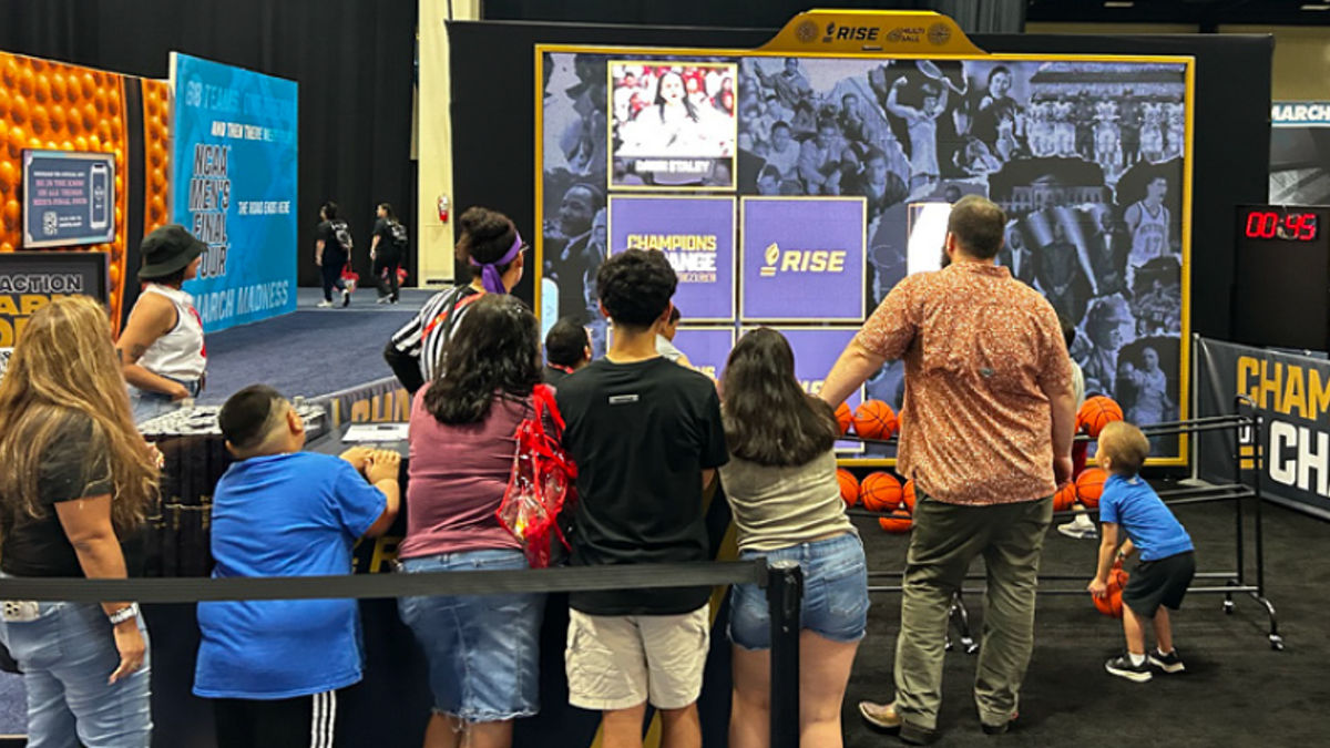 People standing in front of a RISE banner.