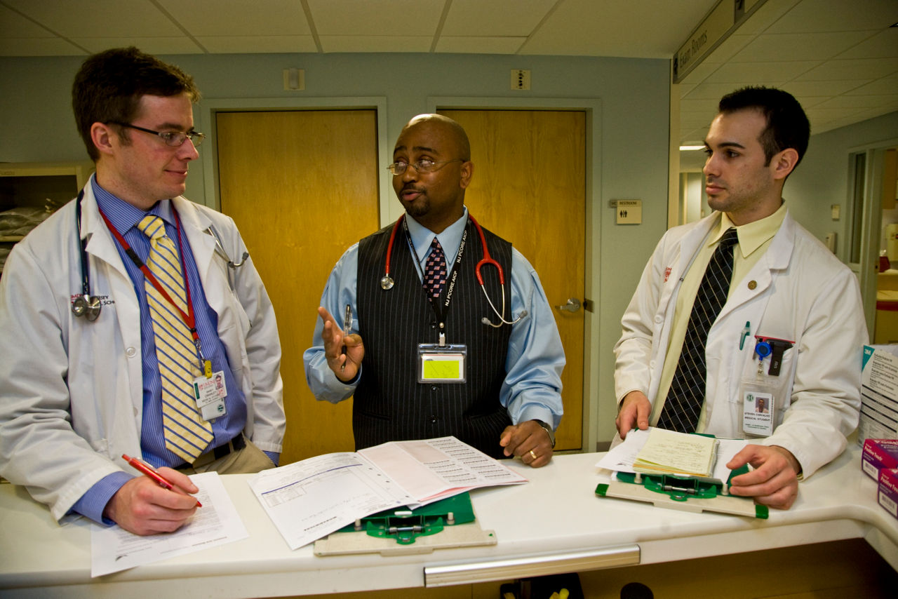  Three doctors collaborating about patient care.