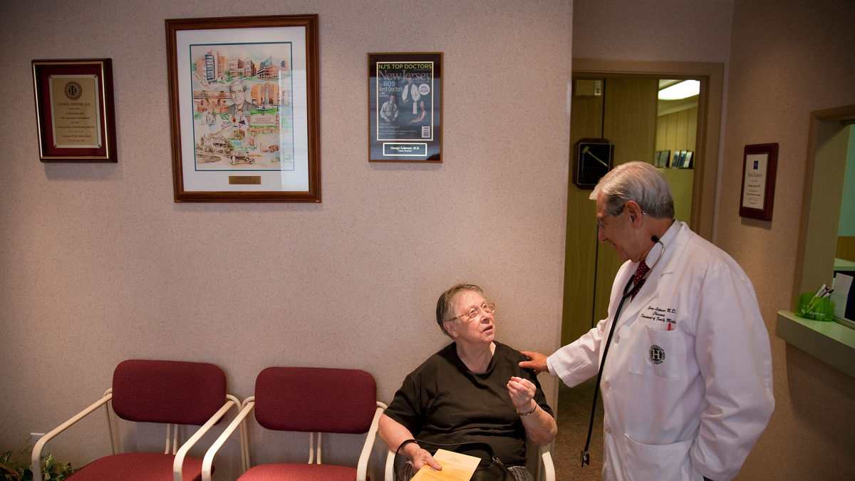 Dr. Leipsner talks with a patient in the waiting room in the office of Dr. George Leipsner in Maywood, NJ.
