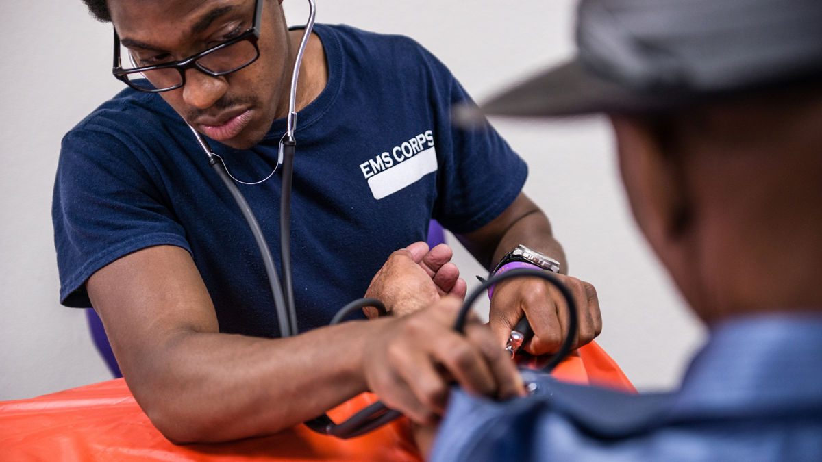 People attend a health fair at a church in East Oakland, California, May 4, 2013. Alameda County Public Health Department's EMS Corps program is helping local health care providers expand and diversify their workforce by training young men and women from the community to be emergency medical professionals.