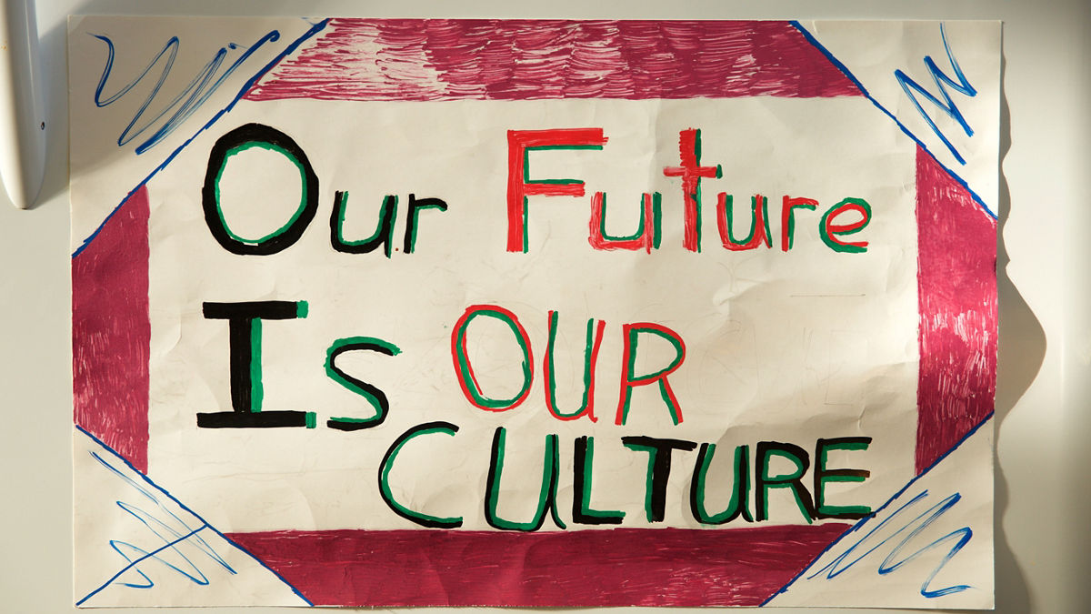A handmade sign reads, "Our Future Is Our Culture."