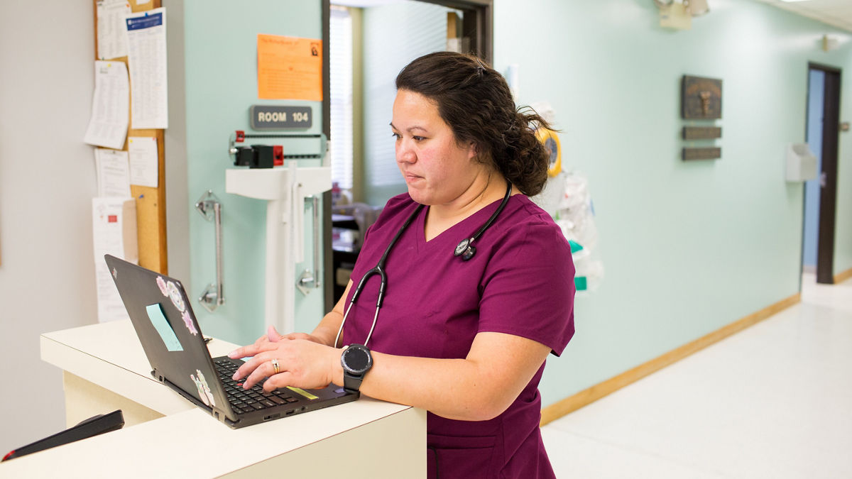 Nurse Jacqueline Reinert takes notes at Bluestem Medical in Quinter, Kansas.