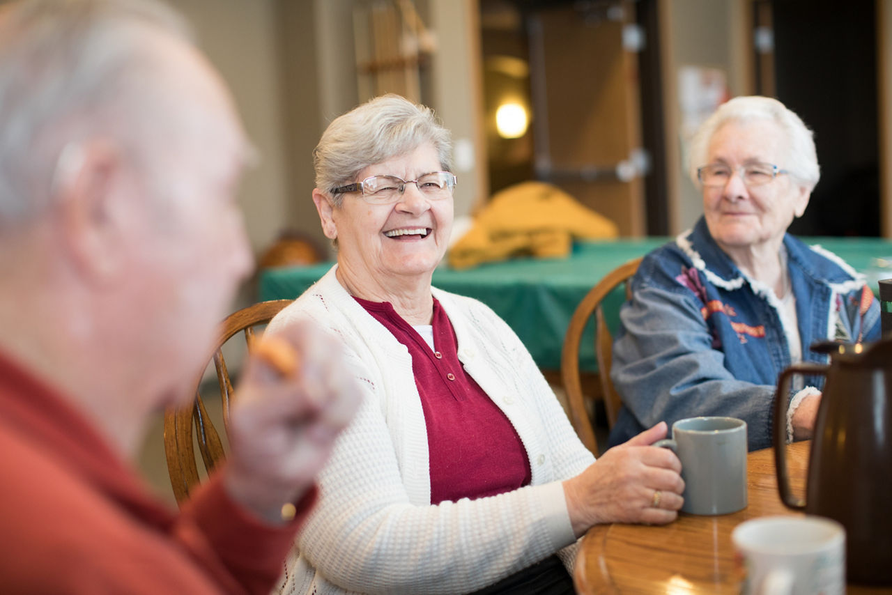 Older adults enjoying comradery in recreation room.