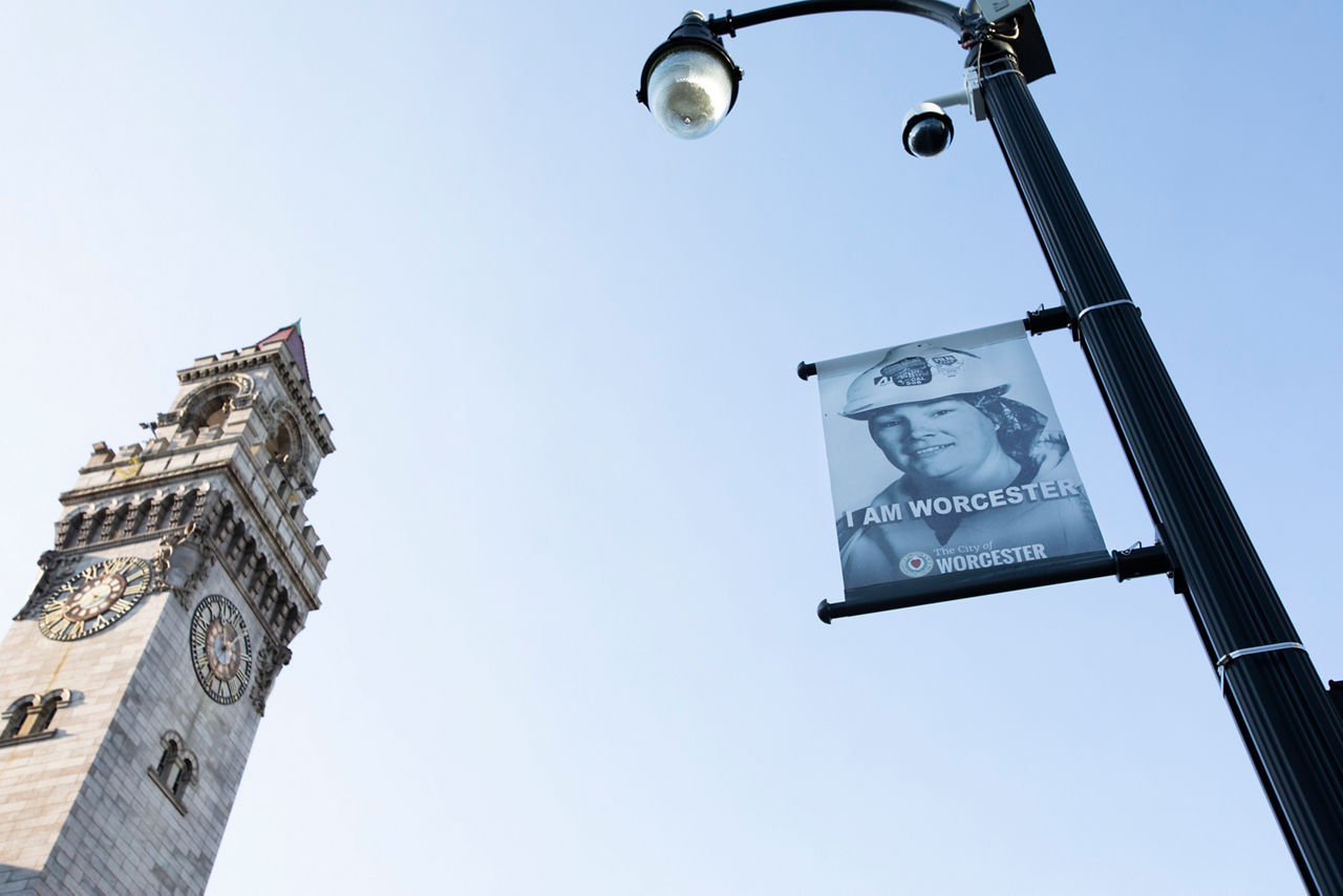 A banner hanging on a solar streetlight.