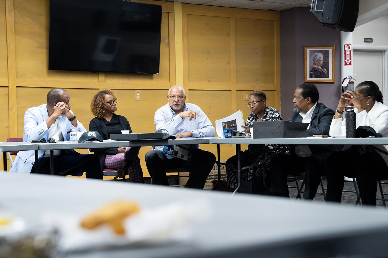 A group of people sitting around a conference table.