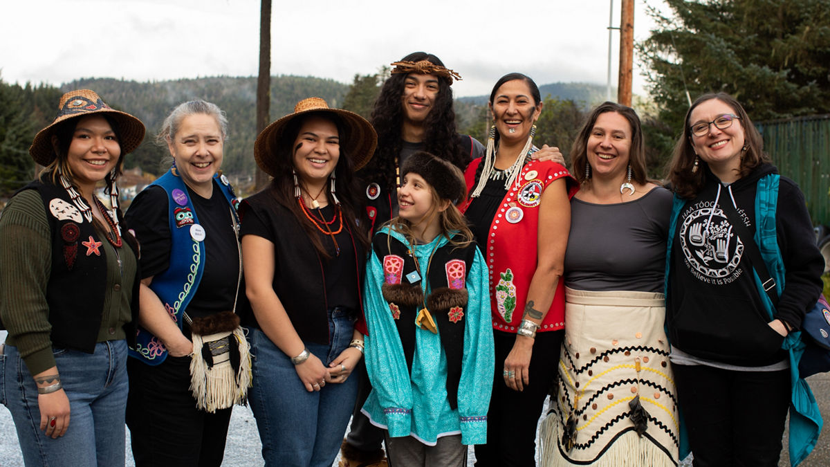 (L-R) Corinne James, Renee Culp, Markayla Katchatag, Keagan Hasselquist, Bodhi Nasiah, Jamiann Hasselquist, Ati Nasiah, and Thomasina Andersen attend a Ku.éex' (Tlingit ceremony) held in Angoon in October 2024, during which the U.S. Navy issued a formal apology for the bombardment of the Angoon community in 1882.