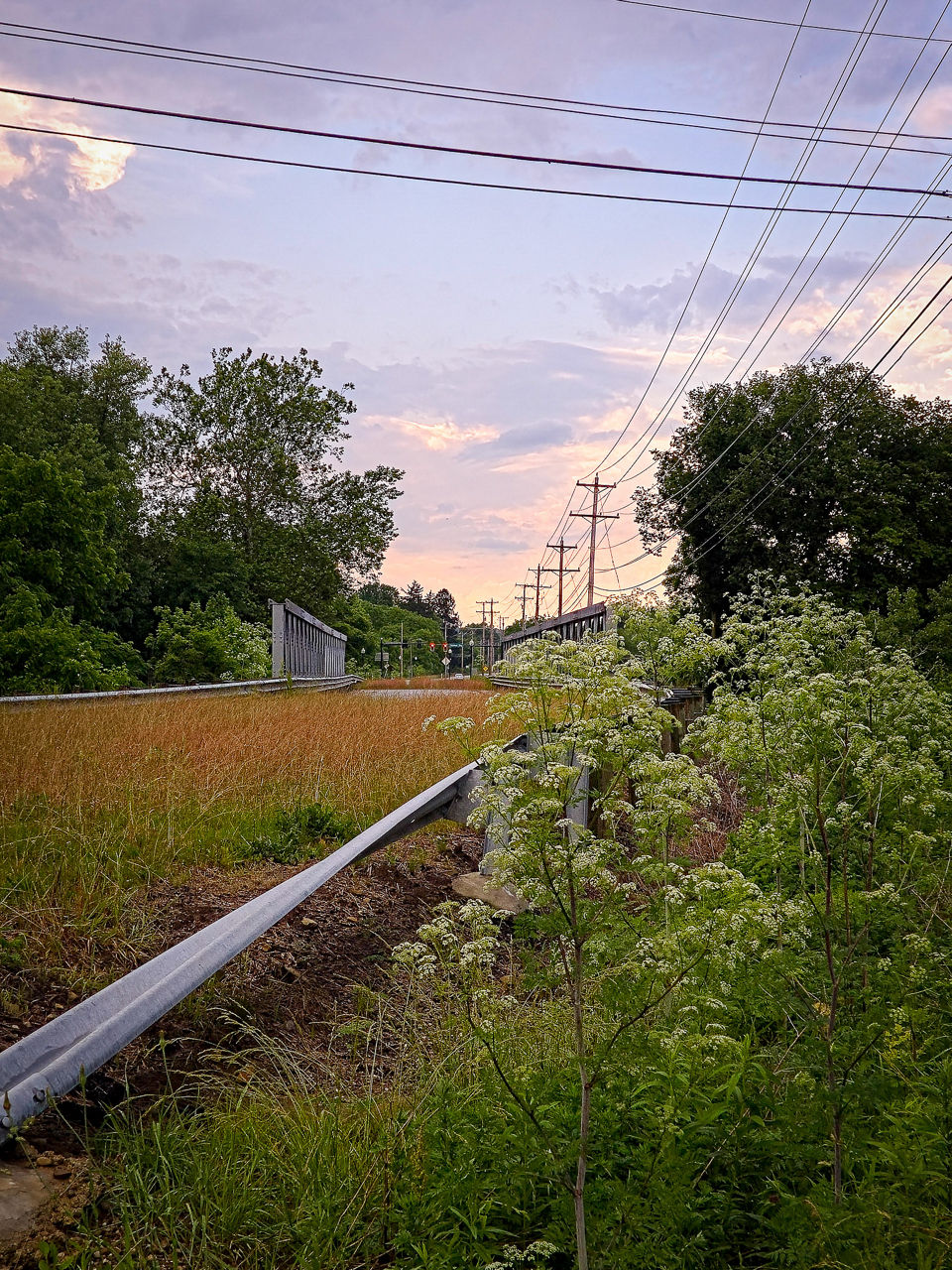 A former bridge remains beside new infrastructure to support housing and development.