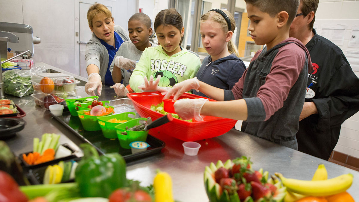 Children enjoy preparing a healthy snack of fruits and vegetables.