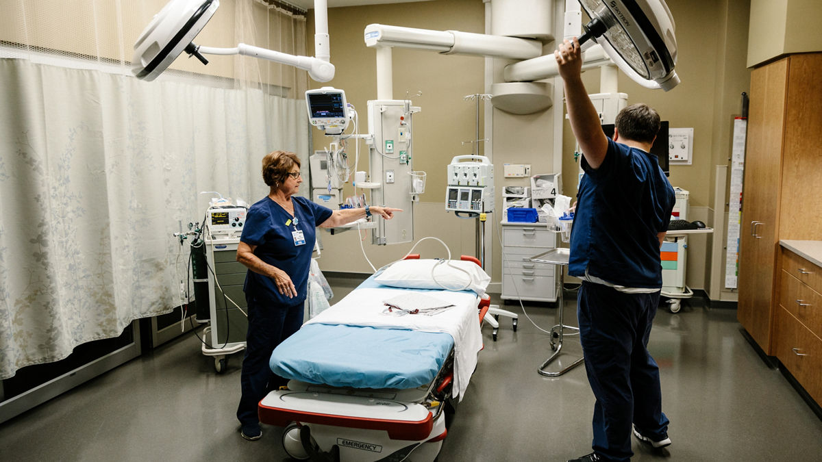 Nurses set up an emergency exam room. 