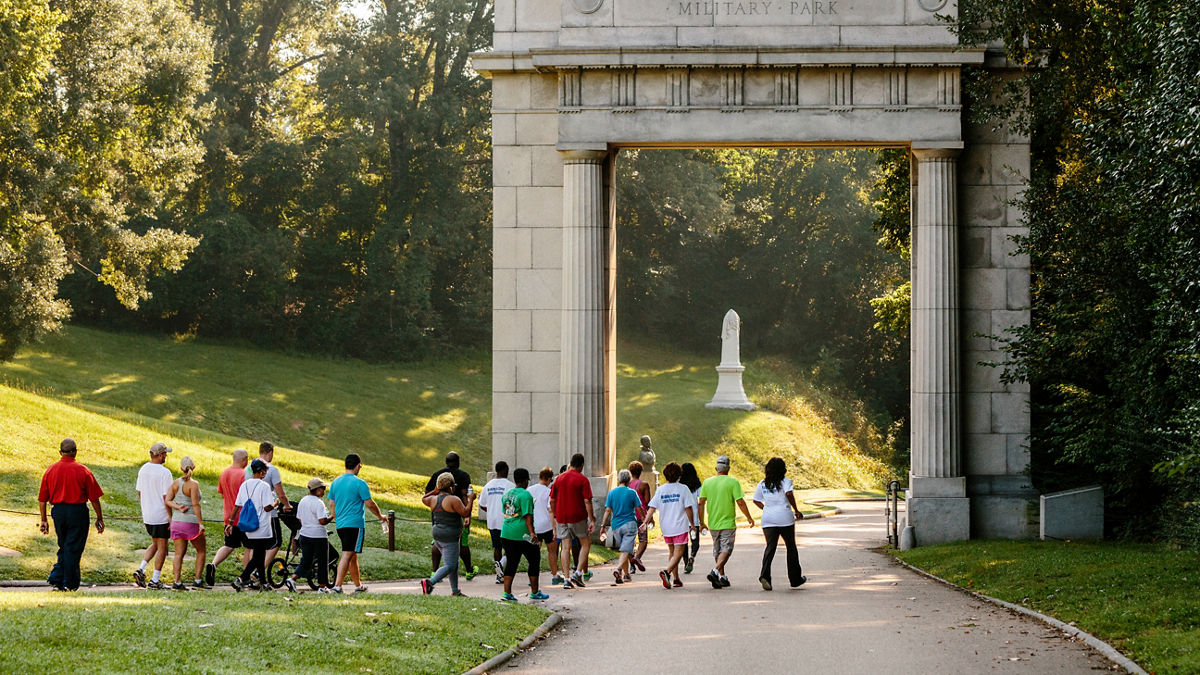 A group of people walking together in a park.
