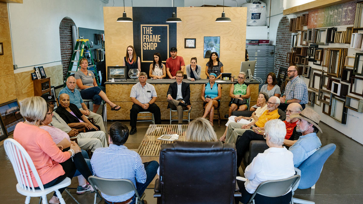 Community town hall meeting in a retail store. 