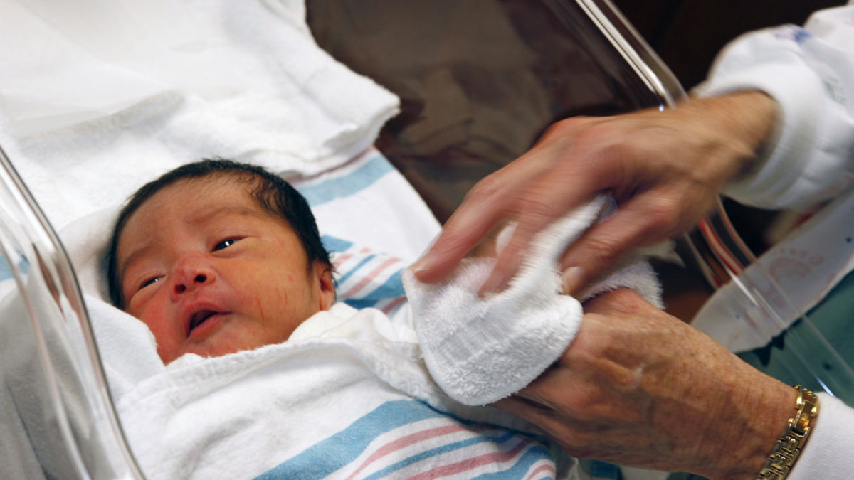 A newborn infant in a baby bassinet.  AnMed Health, Anderson, S.C. MedVerse - Hablamos Juntos