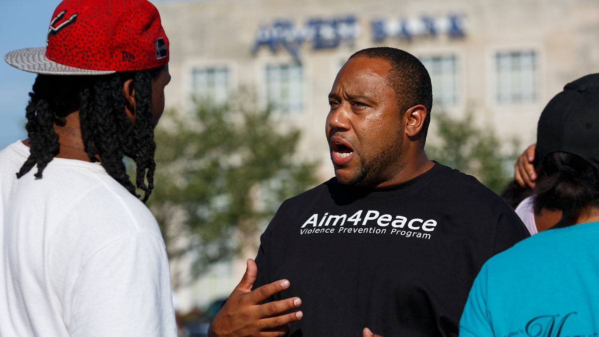 Community members talking at a neighborhood event.