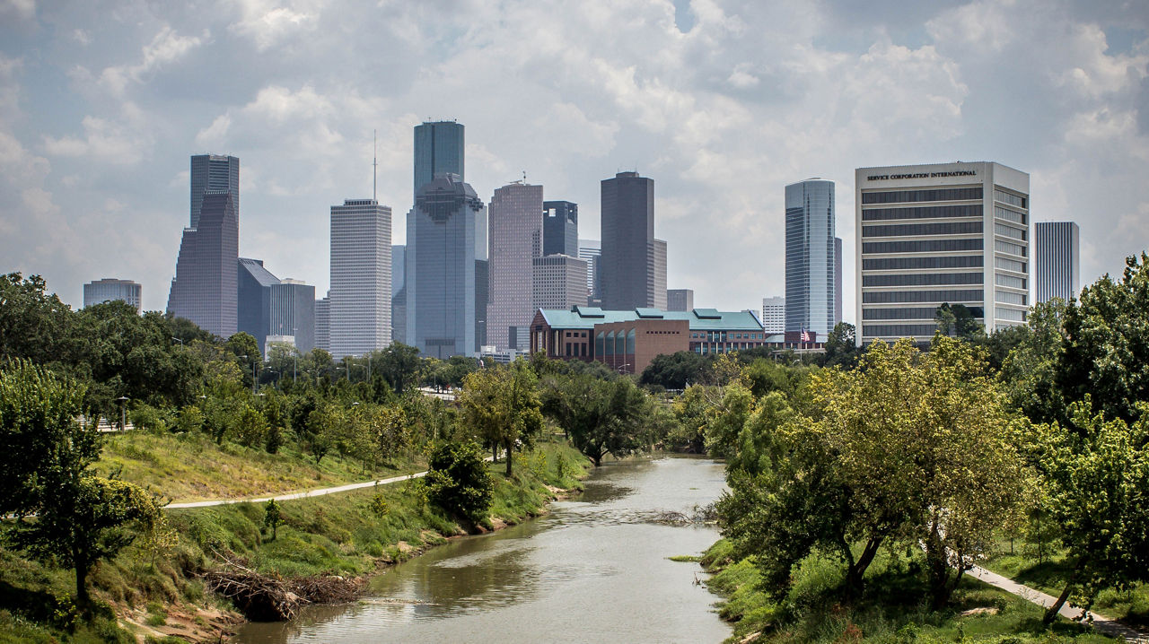 A landscape of a city near a river.