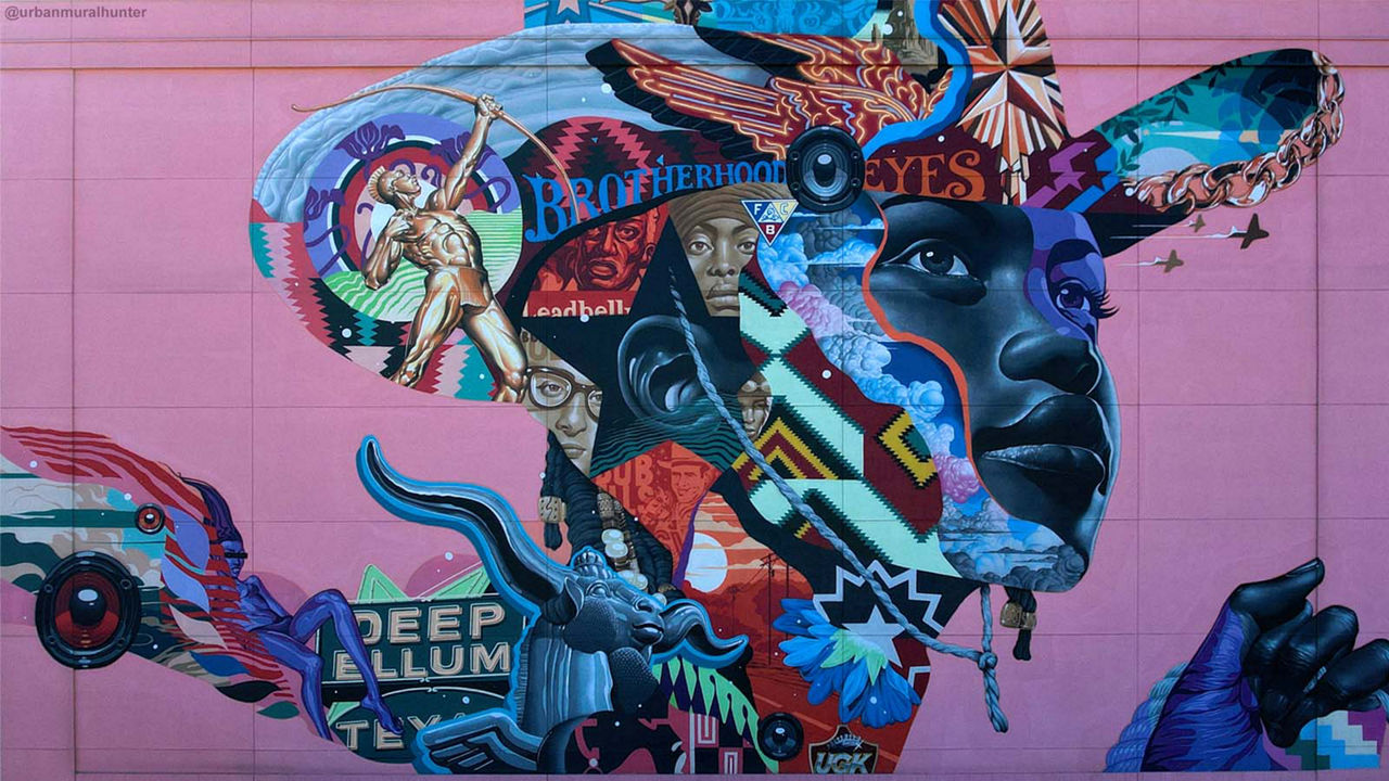A colorful mural of a young Black person looking hopeful against a pink building.