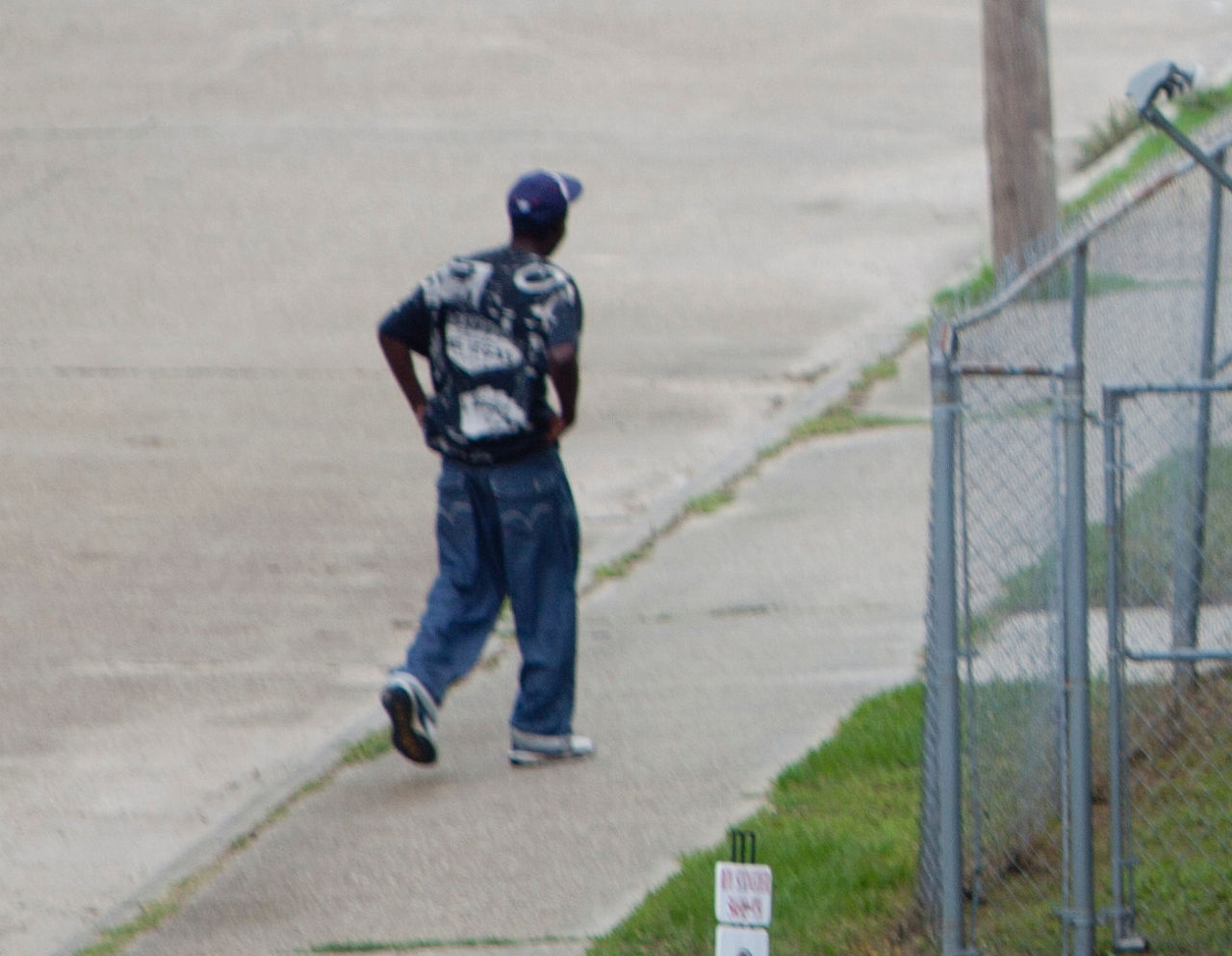 A man walks down the street in New Orleans' Central City area.