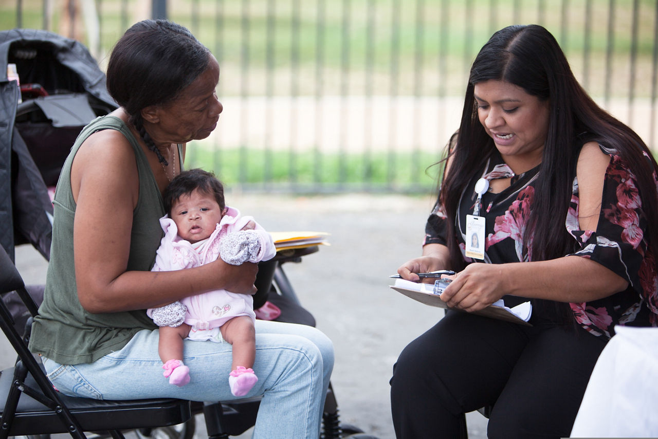 Mobile Medical Unit at the Ina Arbuckle Elementary School. Joanne Brown signs up her 1.5 month old granddaughter (who she had temporary custody of) for state health insurance so that she could be seen at the health unit.