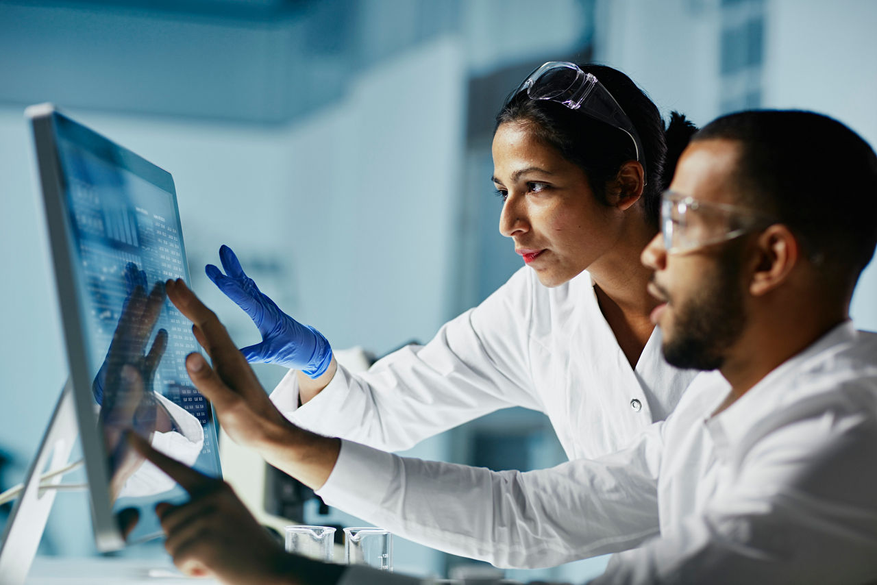 Scientists working on computer in a laboratory.