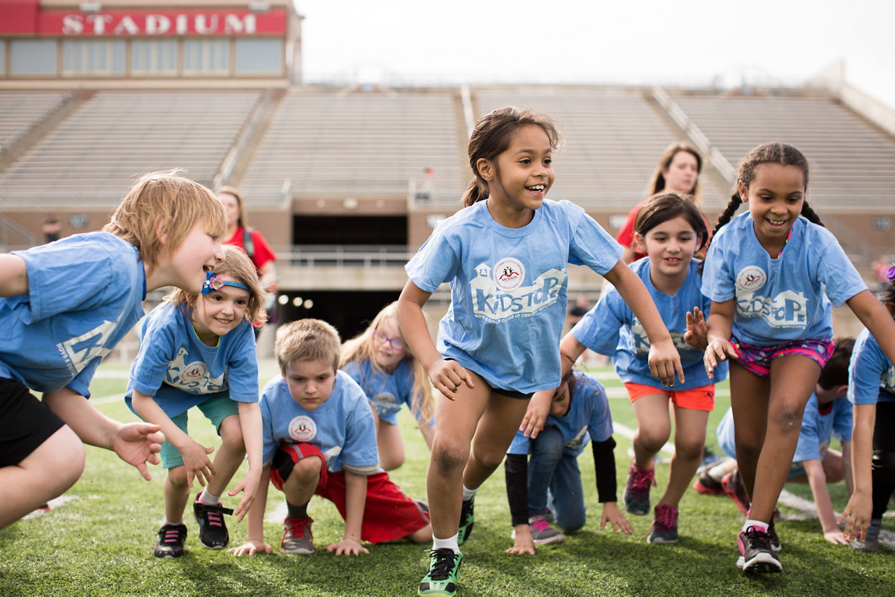 Children participate in a physical activity during the BLEND Earth Day Health & Fitness Expo.St. Cloud, MN. BLEND Expo 1K race highlighting after school program children  (Boys and Girls Club). Signs of Progress.